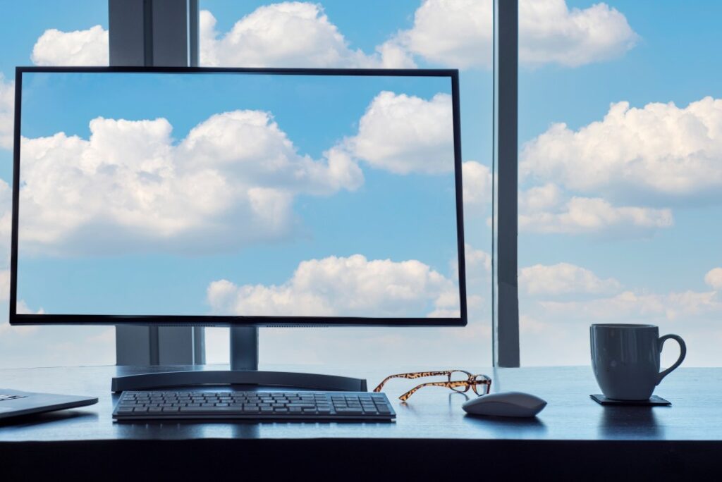 screen and windows with blue sky clouds from office desk t20 vOa46v